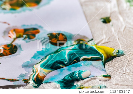 Close-up of multicolor acrylic paints on white paper. 112485147