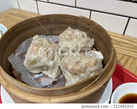 Shumai: Chinese dim sum steamed in a bamboo steamer. Shumai: Chinese dim sum steamed in a bamboo steamer. 112485835