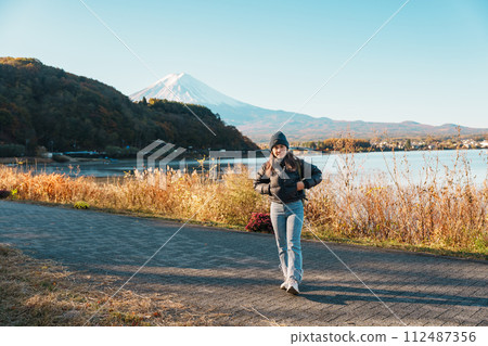 Woman tourist with Fuji Mountain at Lake Kawaguchi, happy Traveler sightseeing Mount Fuji in Fujikawaguchiko, Yamanashi, Japan. Landmark for tourists attraction. Japan Travel, Destination and Vacation Woman tourist with Fuji Mountain at Lake Kawaguchi, happy Traveler sightseeing Mount Fuji in Fujikawaguchiko, Yamanashi, Japan. Landmark for tourists attraction. Japan Travel, Destination and Vacation 112487356