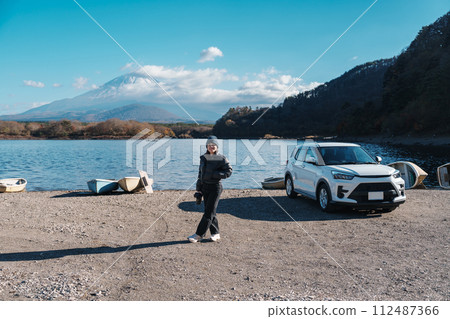 Woman tourist enjoy with Fuji Mountain at Lake Shoji, happy Traveler sightseeing Mount Fuji and road trip Fuji Five Lakes. Landmark for tourists attraction. Japan Travel, Destination and Vacation Woman tourist enjoy with Fuji Mountain at Lake Shoji, happy Traveler sightseeing Mount Fuji and road trip Fuji Five Lakes. Landmark for tourists attraction. Japan Travel, Destination and Vacation 112487366
