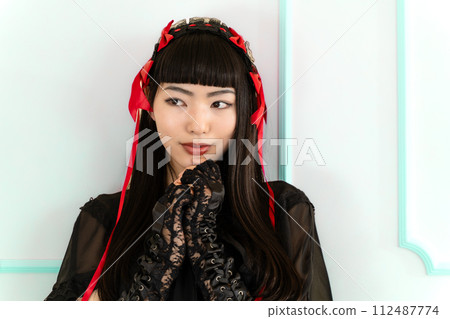 woman wearing gothic loli clothes 112487774