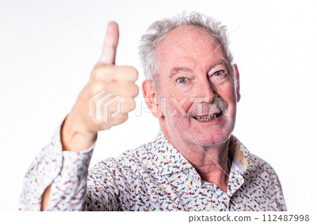 Elderly Man with Thumbs Up: A Portrait of Cheer and Approval Elderly Man with Thumbs Up: A Portrait of Cheer and Approval 112487998