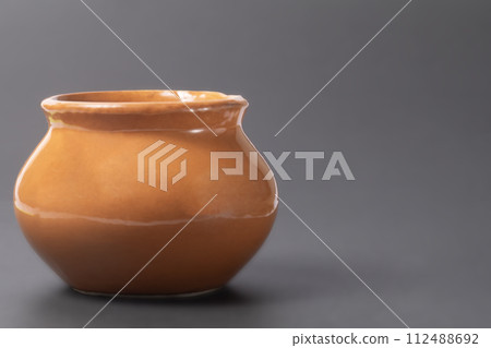 Clay pot on black background with copy space Clay pot on black background with copy space 112488692