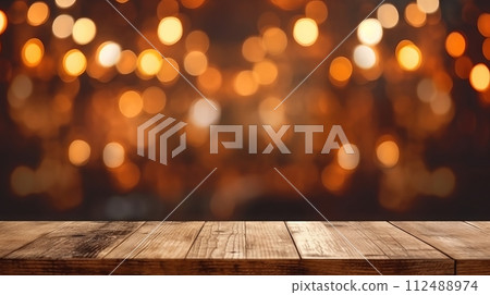 Wooden table top with bokeh lights in the background 112488974