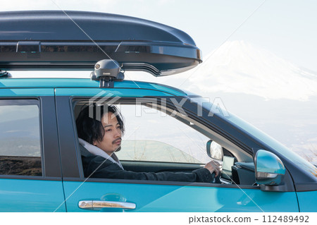 A man in his 30s driving 112489492