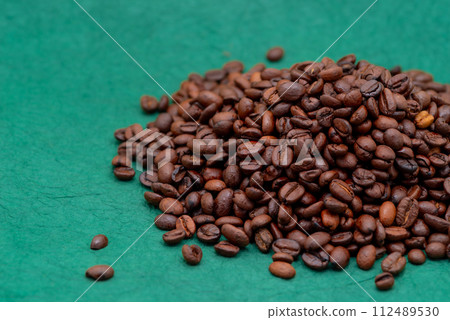 Heap of coffee beans Green background a-1-1 Vivid Heap of coffee beans Green background a-1-1 Vivid 112489530