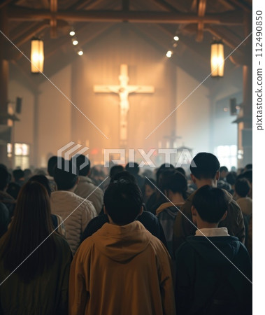 Capturing divine moments: church worship concept Christians, raised hands, earnestly pray and worship to cross in the sacred ambiance of a church building, expressing faith and spiritual connection. 112490850