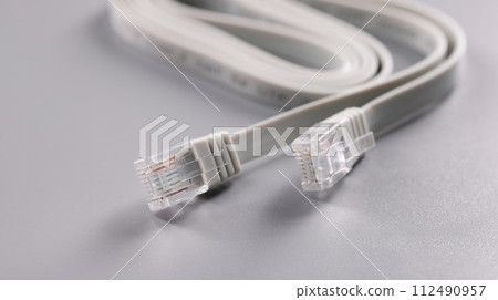 Closeup of rj45 cable on gray background Closeup of rj45 cable on gray background 112490957