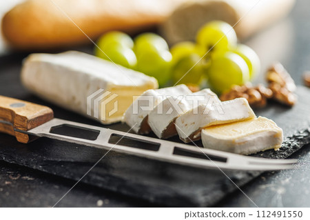 Close-up of cheese and grapes on slate 112491550