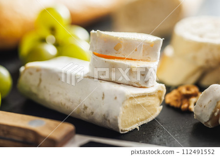 Close-up of cheese and grapes on slate 112491552