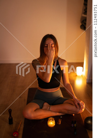 Meditation and breathing during yoga classes. The girl holds her fingers on her forehead and breathes. Meditation and breathing during yoga classes. The girl holds her fingers on her forehead and breathes. 112493751