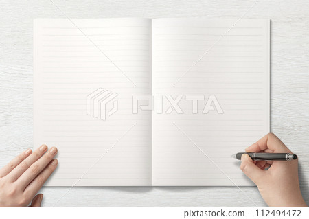 Background texture of a hand writing or drawing on a notebook on the table 112494472