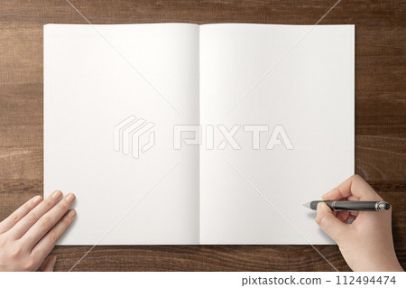 Background texture of a hand writing or drawing on a notebook on the table 112494474