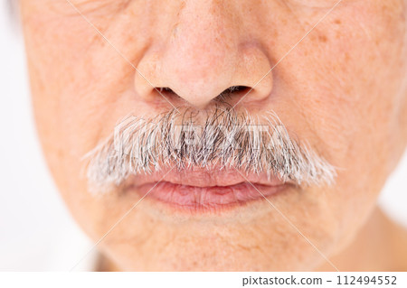 Senior male beauty mouth close up 112494552