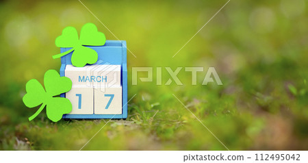 Save the date white block calendar for St Patrick's Day, March 17 on green background. 112495042