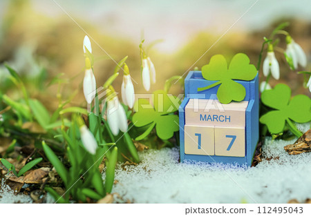 Save the date white block calendar for St Patrick's Day, March 17 on green background. 112495043