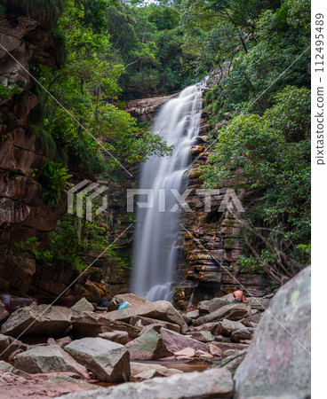 Tranquil Waterfall Oasis in a Lush Forest Setting Tranquil Waterfall Oasis in a Lush Forest Setting 112495489
