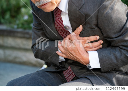 Senior man suit heart attack sitting Senior man suit heart attack sitting 112495599