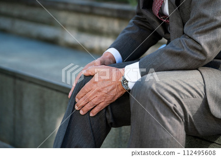 穿著西裝的老人膝蓋疼痛 112495608