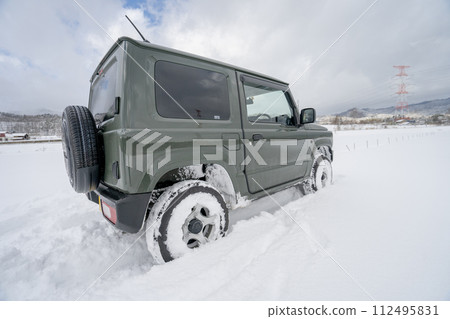 snowy mountain snowy road 4WD car snow driving 112495831