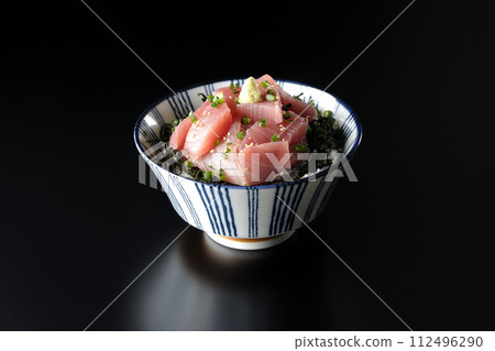 Photograph of bowl of chopped tuna against a black background Photograph of bowl of chopped tuna against a black background 112496290