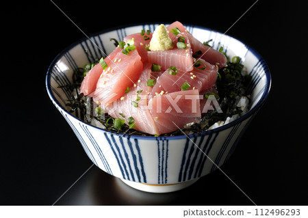 Photograph of bowl of chopped tuna against a black background Photograph of bowl of chopped tuna against a black background 112496293