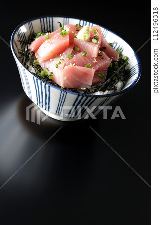 Photograph of bowl of chopped tuna against a black background Photograph of bowl of chopped tuna against a black background 112496318