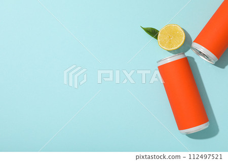 Tin can and lemon on blue background, space for text Tin can and lemon on blue background, space for text 112497521