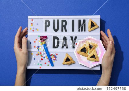 Purim holiday concept, with traditional symbols and decor. 112497568