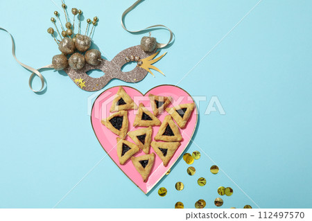 A mask with traditional cookies for the day of Purim. 112497570