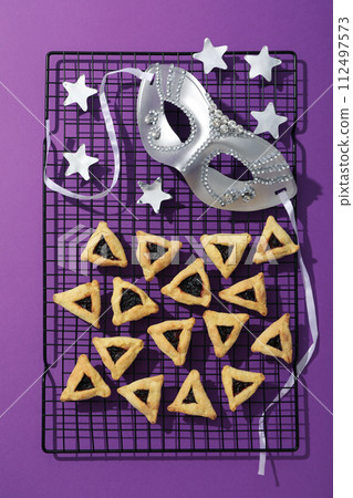 A mask with traditional cookies for the day of Purim. 112497573