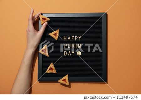 A mask with traditional cookies for the day of Purim. 112497574