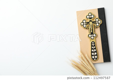 Cross on book and spikelets on white background, space for textCross on book and spikelets on white background, space for text 112497587