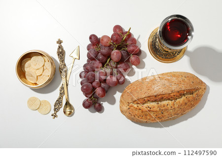 Bread, grapes, cutlery and cup of wine on white background, top view Bread, grapes, cutlery and cup of wine on white background, top view 112497590