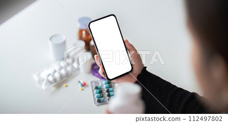 Mock up smartphone smartphone in the hands of patient of medicine. instruction for use Mock up smartphone smartphone in the hands of patient of medicine. instruction for use 112497802