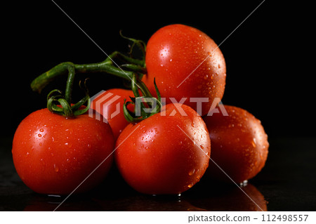 Fresh ripe red tomatoes branch Fresh ripe red tomatoes branch 112498557