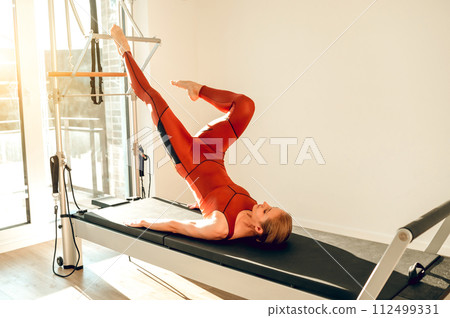 Athletic woman in sports wear training toughness and balance 112499331