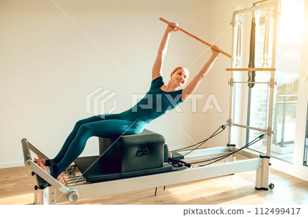 Fit woman instructor in yoga class promoting healthy lifestyle and physical activity Fit woman instructor in yoga class promoting healthy lifestyle and physical activity 112499417