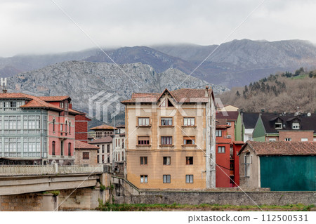 City skyline with mountains backdrop and a bridge in the foreground 112500531