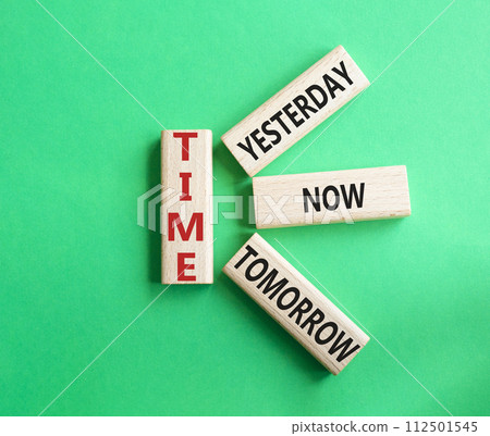 Time - Yesterday Now Tomorrow. Wooden cubes with words Time. Beautiful green background. Business and Time concept. Copy space. Time - Yesterday Now Tomorrow. Wooden cubes with words Time. Beautiful green background. Business and Time concept. Copy space. 112501545