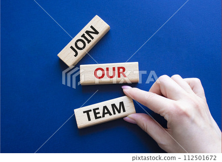 Join our team symbol. Wooden blocks with words Join our team. Beautiful deep blue background. Businessman hand. Business and Join our team concept. Copy space. 112501672