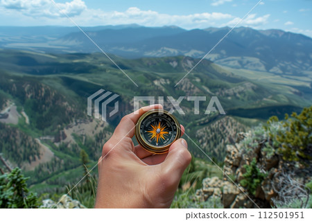 AI-generated content. Hand with compass pointing towards mountain range 112501951