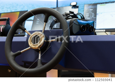 Ship control panel with steering wheel and VR headset on the desk Ship control panel with steering wheel and VR headset on the desk 112503041