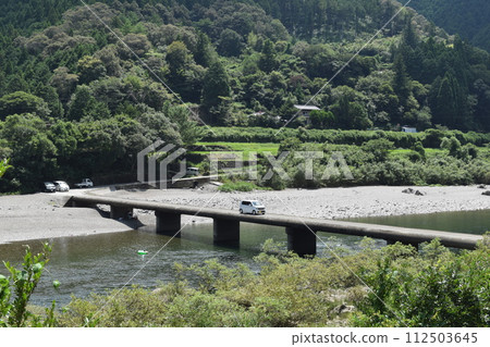 Crossing cars and submerged bridge Crossing cars and submerged bridge 112503645