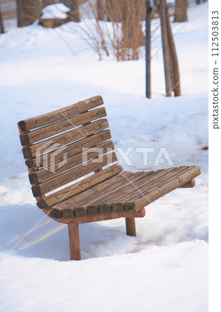 Park bench covered in snow Park bench covered in snow 112503813