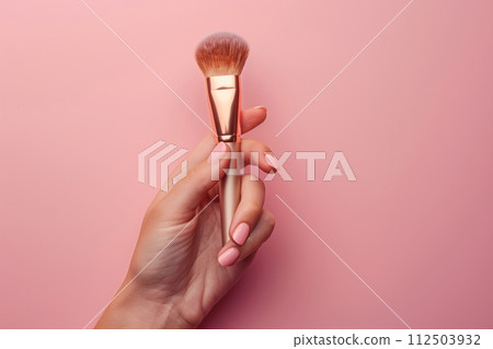 Hand holds cosmetic brush on pink background. Generative AI Hand holds cosmetic brush on pink background. Generative AI 112503932