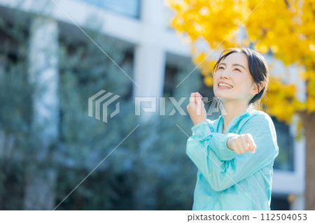A young woman stretching in the park A young woman stretching in the park 112504053