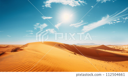 Scenic view of vast desert dunes with patterns of wind-swept sand under a bright sun in a cloud-dappled blue sky. Scenic view of vast desert dunes with patterns of wind-swept sand under a bright sun in a cloud-dappled blue sky. 112504661