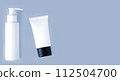 White bottle and tube of cosmetic products background 112504700