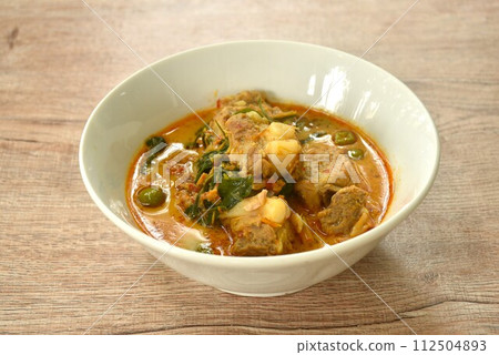 boiled pork bone with basil and chili in coconut milk curry soup on bowl boiled pork bone with basil and chili in coconut milk curry soup on bowl 112504893